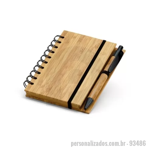 Caderno ecológico personalizado - Caderno A6 espiral de capa dura em bambu. Com 140 páginas pautadas de papel reciclado e suporte para esferográfica. Esferográfica em bambu inclusa. A cor e o resultado da impressão nos materiais naturais pode variar entre produtos. 105 x 148 mm