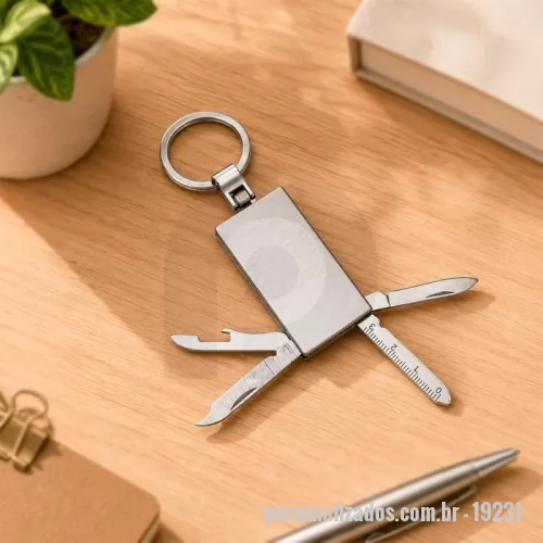 Chaveiro personalizado - Canivete com estrutura em aço inox e quatro funções diferentes: lâmina de corte, lixa de unha, abridor de garrafas e uma mini régua de 3 centímetros, além de argola metálica.