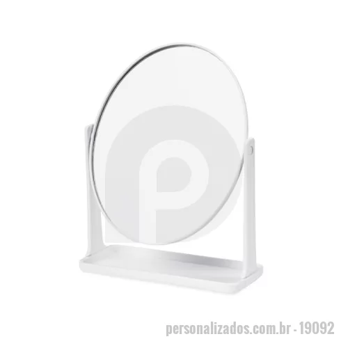 Espelho personalizado -  Espelho de mesa giratório com face única sem aumento em formato oval. Possui estrutura em plástico e base com espaço para organizar pequenos objetos.
