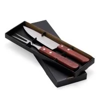 Kit Churrasco 2 Peças. Este conjunto vem em um estojo de papel kraft. O kit inclui uma faca de 7 polegadas e um garfo, ambos em inox com cabos de madeira. Um churrasco de respeito merece utensílios de qualidade!