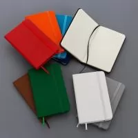 Caderneta com capa emborrachada, marca-páginas em fita de cetim e fechamento em elástico. Possui aproximadamente 80 folhas pardas não pautadas.  Largura: 9 cm Comprimento: 14 cm Espessura: 1,4 cm Medidas aproximadas para gravação(CxL): 7 cm x 12 cm Peso aproximado(g): 108